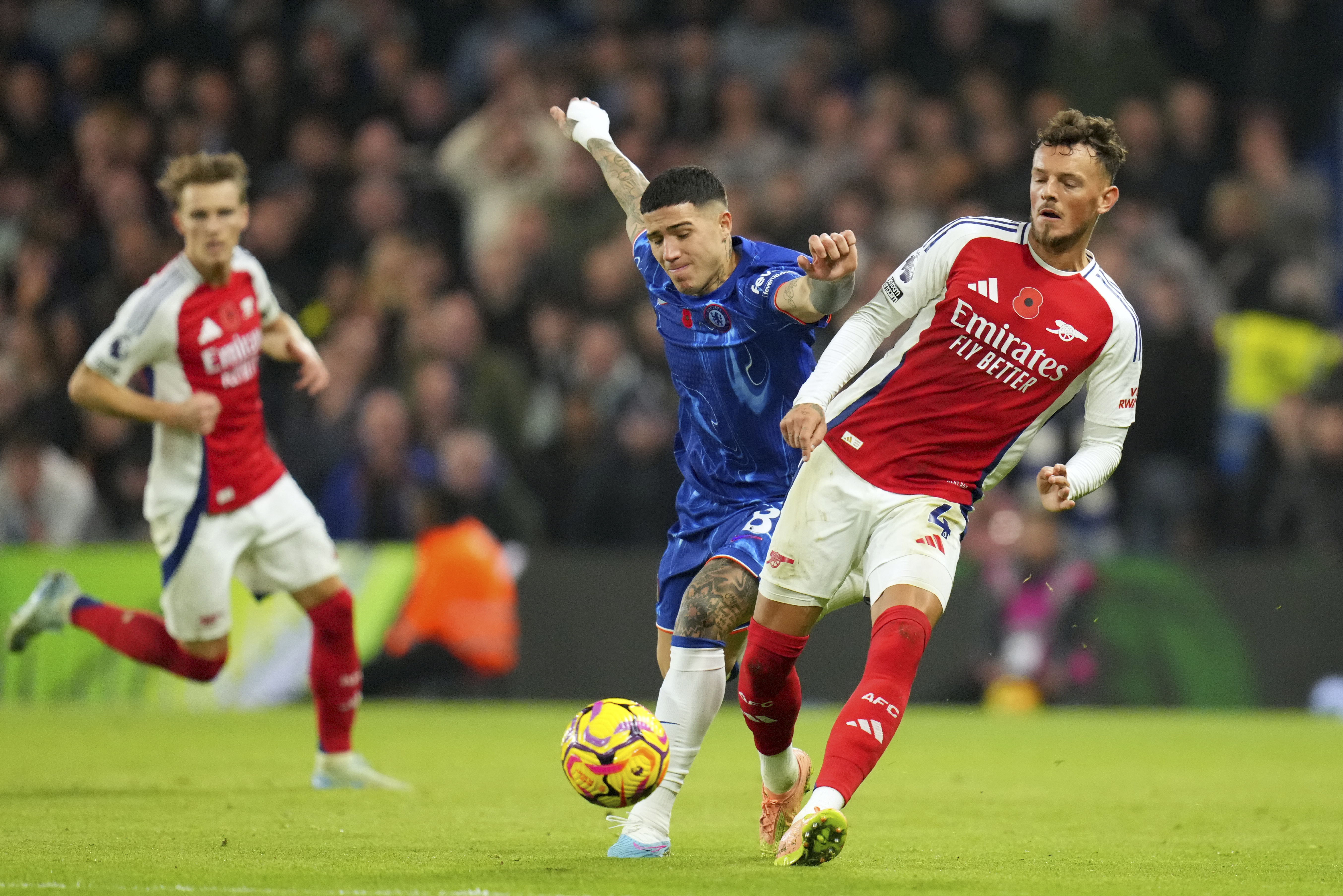 Chelsea's Enzo Fernandez vies for the ball with Arsenal's Ben White, right, during the English Premier League soccer match between Chelsea and Arsenal at Stamford Bridge stadium in London, Sunday, Nov. 10, 2021.