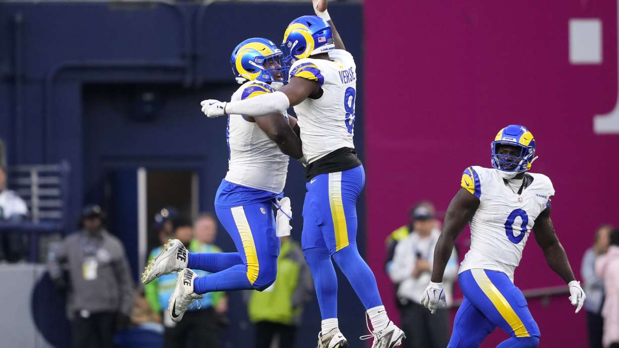 Los Angeles Rams defensive tackle Kobie Turner, left, celebrates with linebacker Jared Verse (8) during the second half of an NFL football game against the Seattle Seahawks in Seattle, Sunday, Nov. 3, 2024.