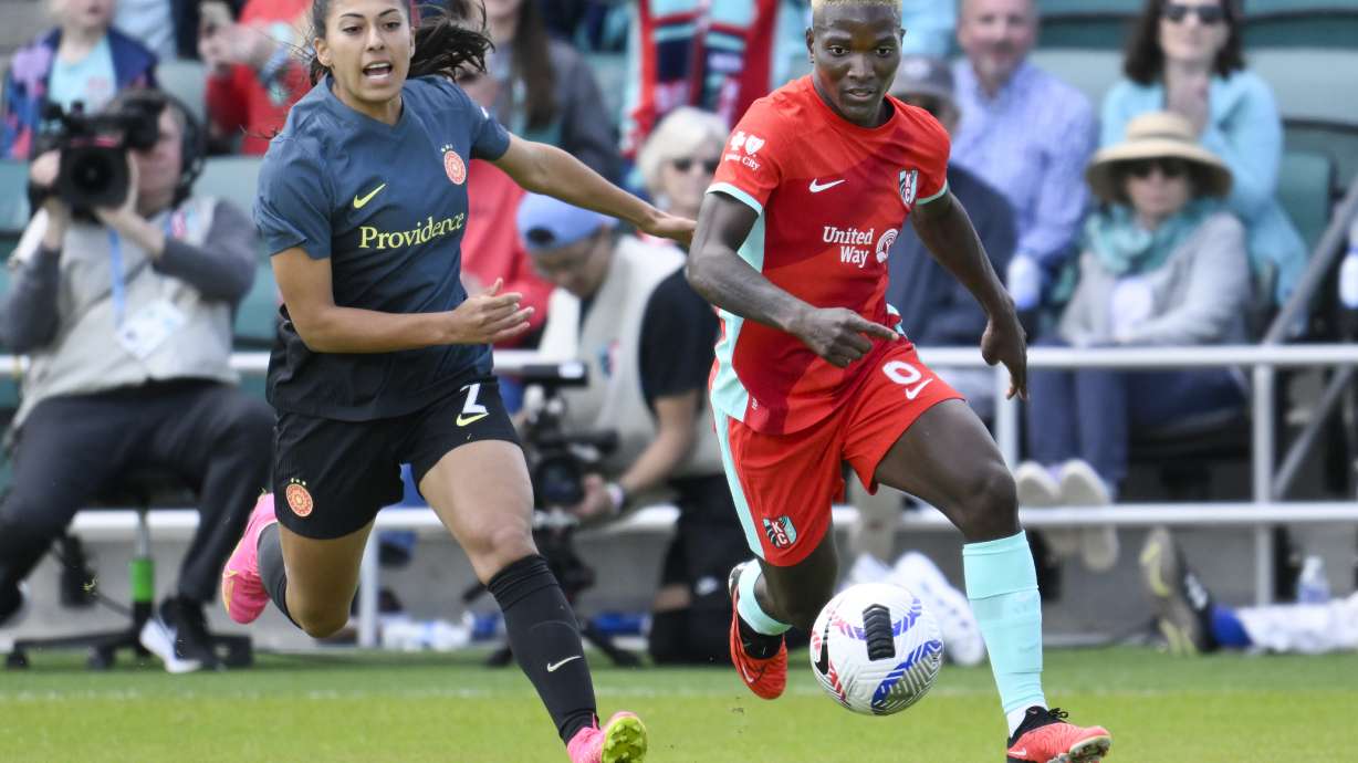 FILE - Kansas City Current forward Temwa Chawinga (6) and Portland Thorns FC defender Reyna Reyes (2) chase after a ball during an NWSL soccer match at CPKC Stadium, March 16, 2024, in Kansas City, Mo.