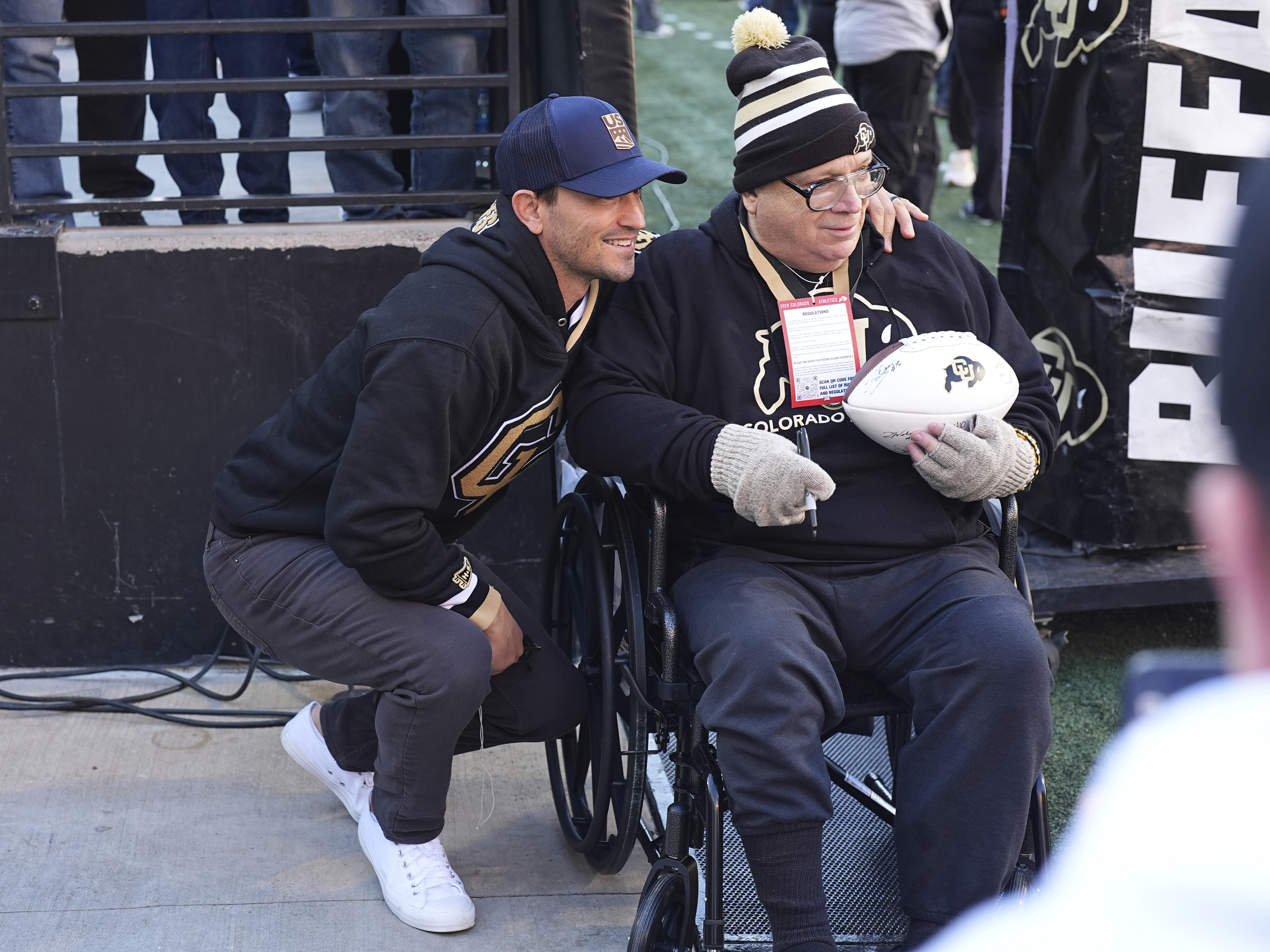 Former skier and football player Jeremy Bloom, left, poses for a photograph with Colorado football fan Riley Rhoades before Colorado hosts Utah in an NCAA college football game Saturday, Nov. 16, 2024, in Boulder, Colo. 