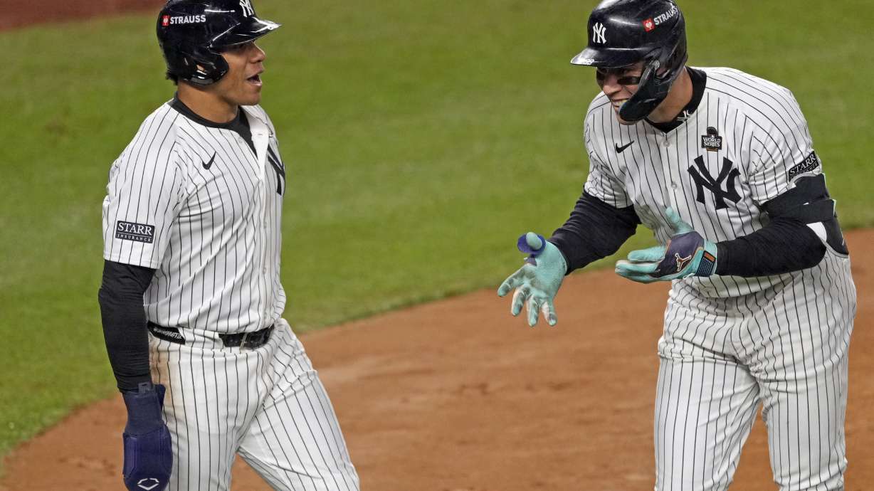 New York Yankees' Aaron Judge, right, celebrates with Juan Soto after both scored on Judge's two-run home run against the Los Angeles Dodgers during the first inning in Game 5 of the baseball World Series, Wednesday, Oct. 30, 2024, in New York.