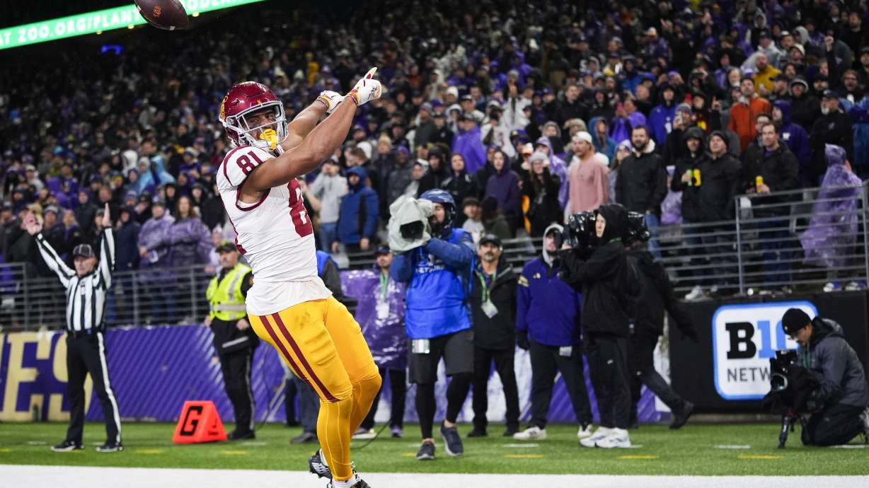 Southern California wide receiver Kyle Ford, foreground, reacts after scoring against Washington during the second half of an NCAA college football game Saturday, Nov. 2, 2024, in Seattle.