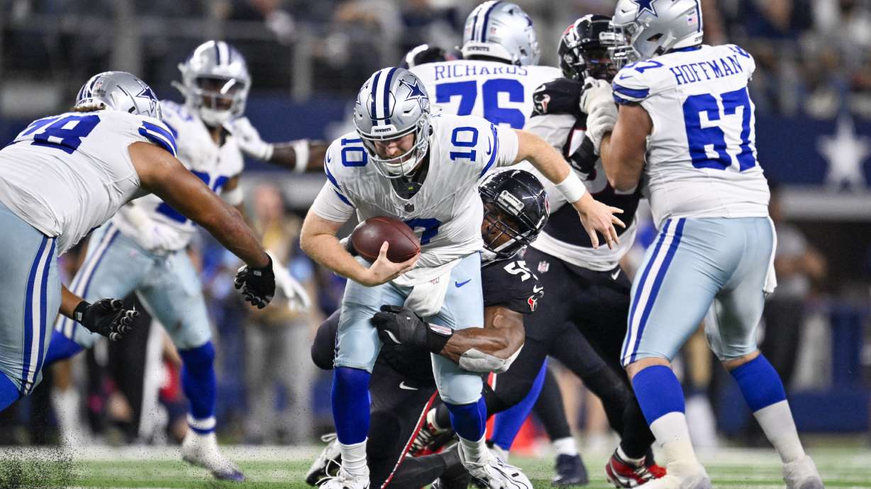 Dallas Cowboys quarterback Cooper Rush (10) is sacked by Houston Texans defensive end Danielle Hunter during the second half of an NFL football game, Monday, Nov. 18, 2024, in Arlington, Texas.