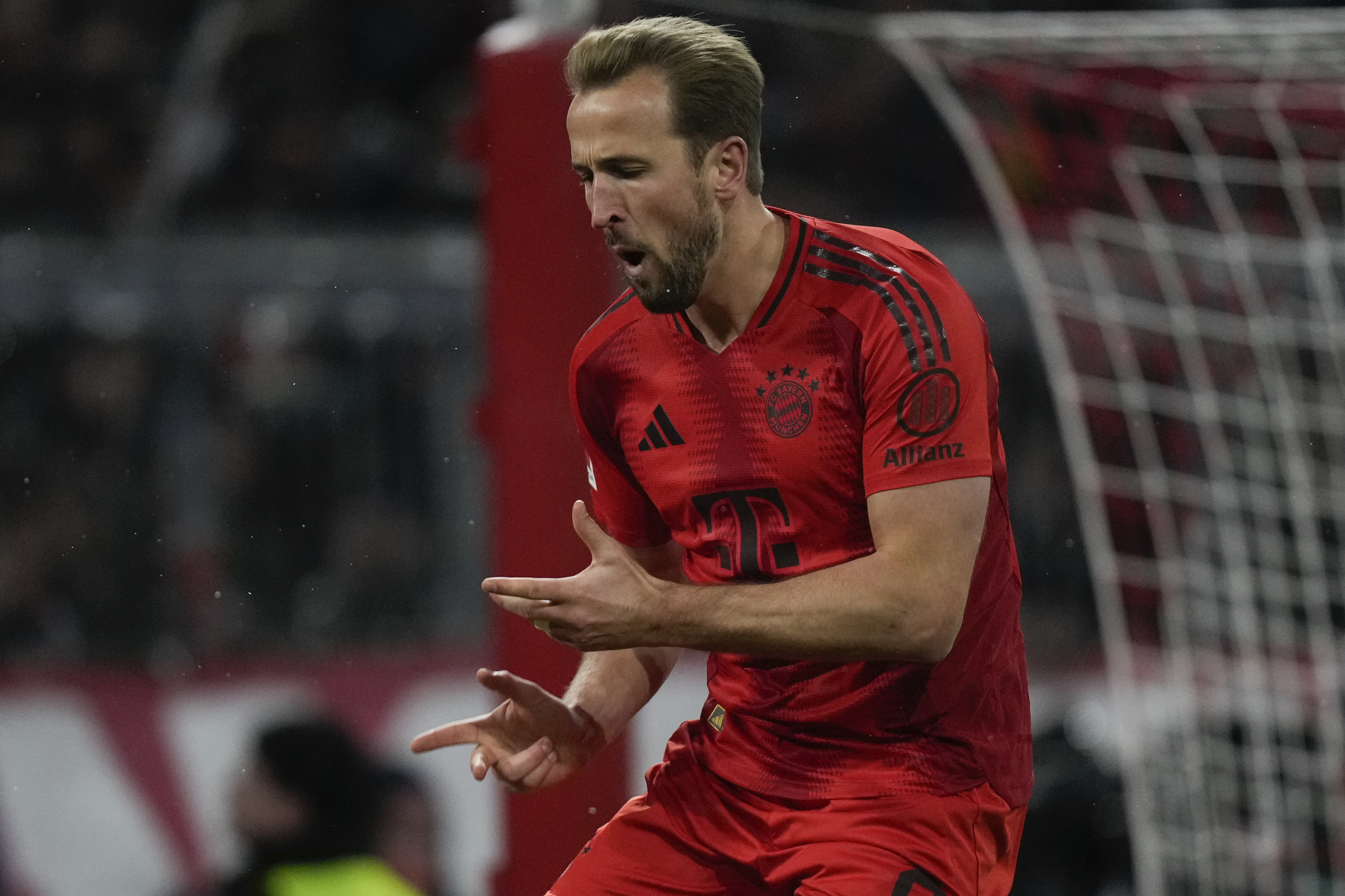 Bayern's Harry Kane celebrates after scoring the opening goal with the penalty kick during the Bundesliga soccer match between Bayern Munich and Augsburg at the Allianz Arena in Munich, Germany, Friday, Nov. 22, 2024.