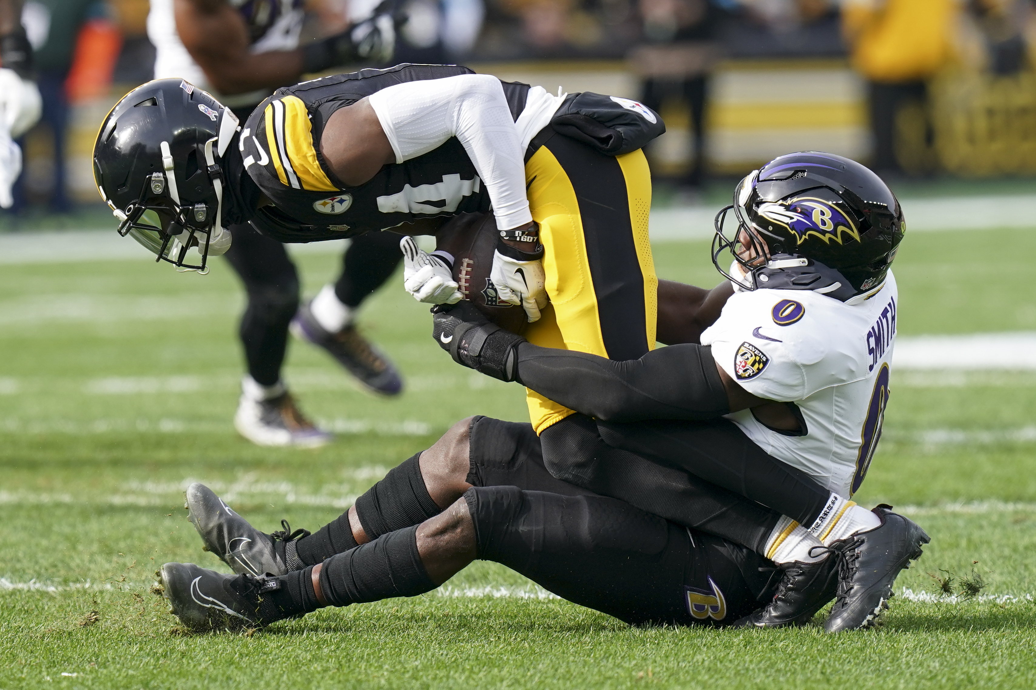 Baltimore Ravens linebacker Roquan Smith (0) tackles Pittsburgh Steelers wide receiver George Pickens during the first half of an NFL football game, Sunday, Nov. 17, 2024, in Pittsburgh.