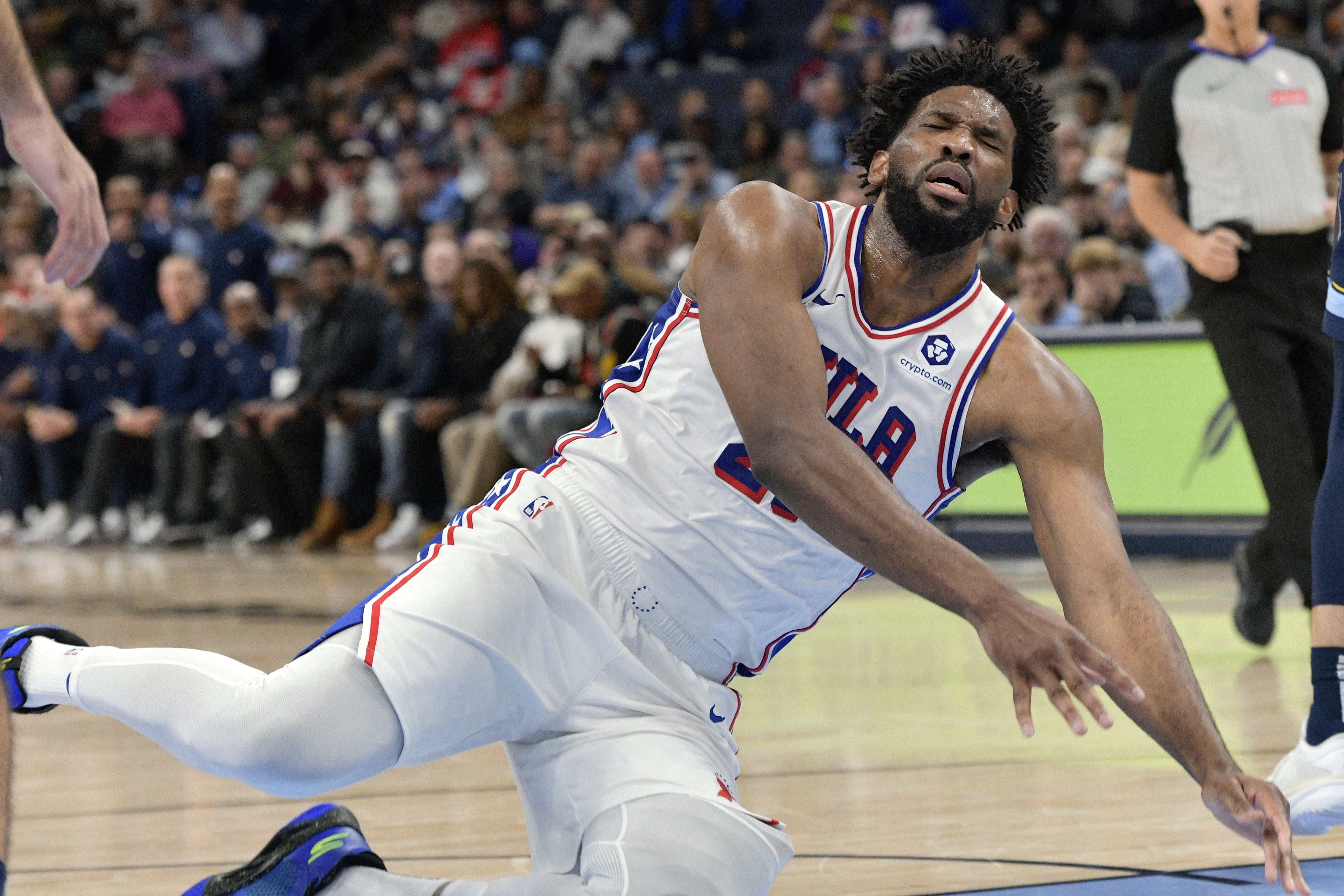 Philadelphia 76ers center Joel Embiid falls to the court in the second half of an NBA basketball game against the Memphis Grizzlies Wednesday, Nov. 20, 2024, in Memphis, Tenn.