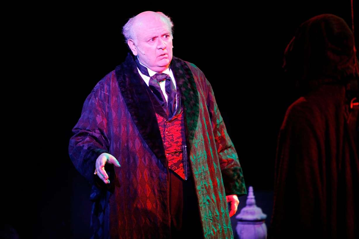 Richard Wilkins performs as Scrooge in "A Christmas Carol" at Hale Centre Theatre. His son Brinton will be portraying the role using the same dressing gown.