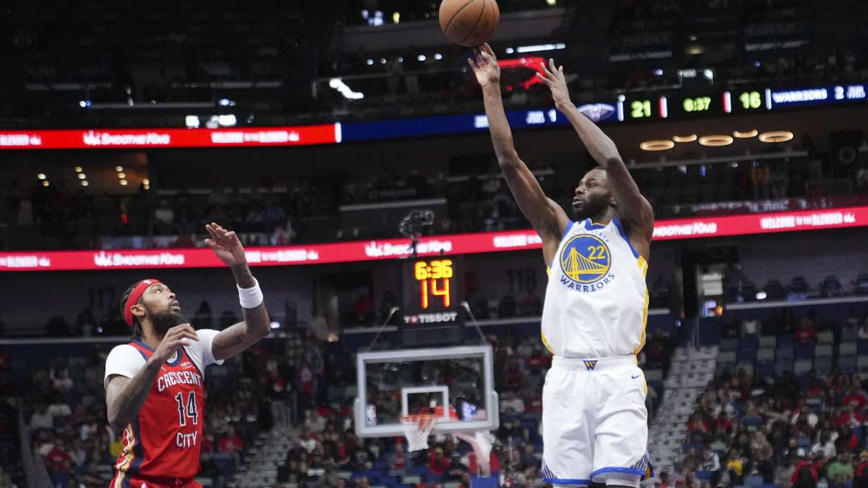 Golden State Warriors forward Andrew Wiggins (22) shoots against New Orleans Pelicans forward Brandon Ingram (14) in the first half of an Emirates NBA Cup basketball game in New Orleans, Friday, Nov. 22, 2024.
