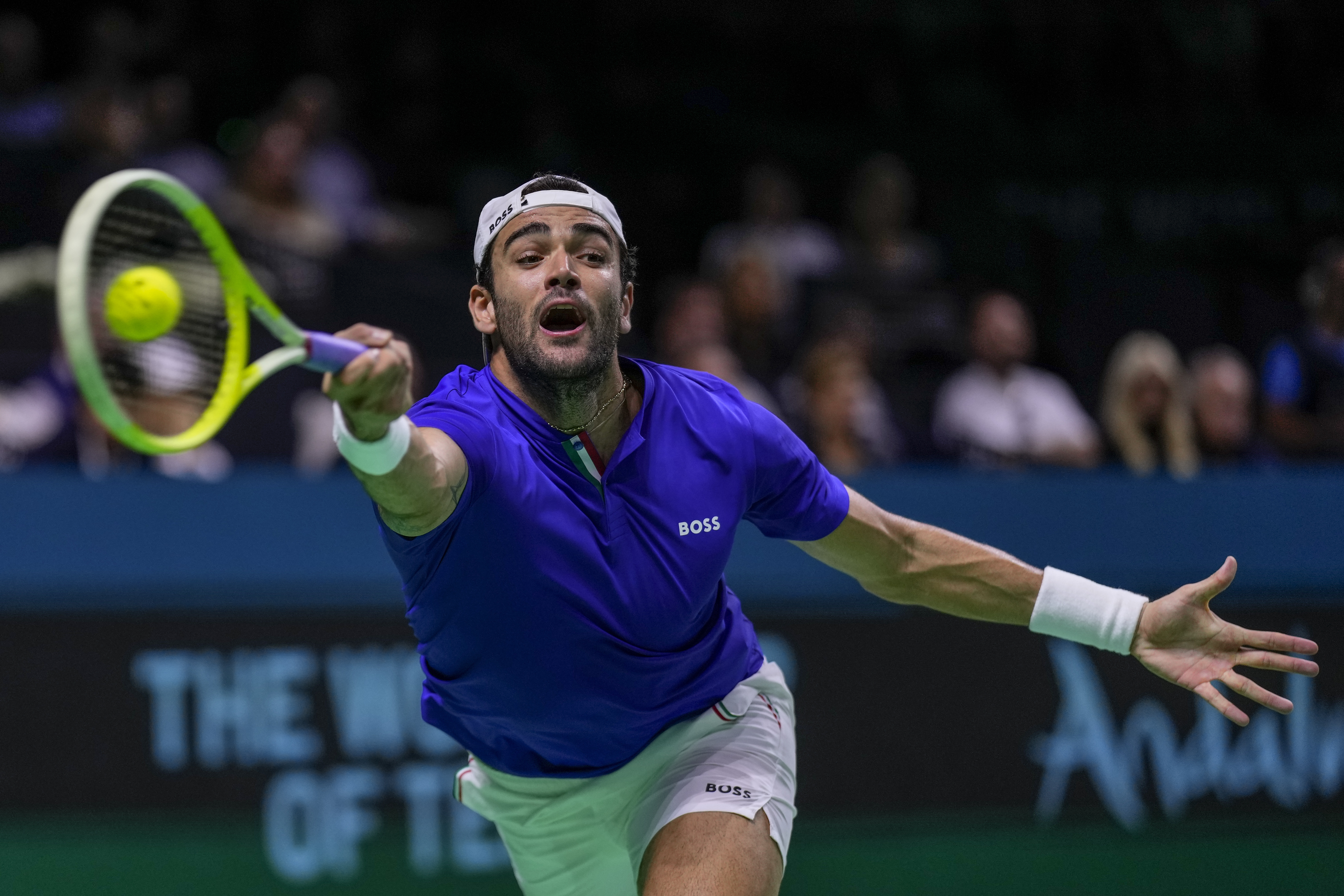 Italy's Matteo Berrettini returns the ball against Australia's Thanasi Kokkinakis during the Davis Cup semifinal at the Martin Carpena Sports Hall in Malaga, southern Spain, on Saturday, Nov. 23, 2024.