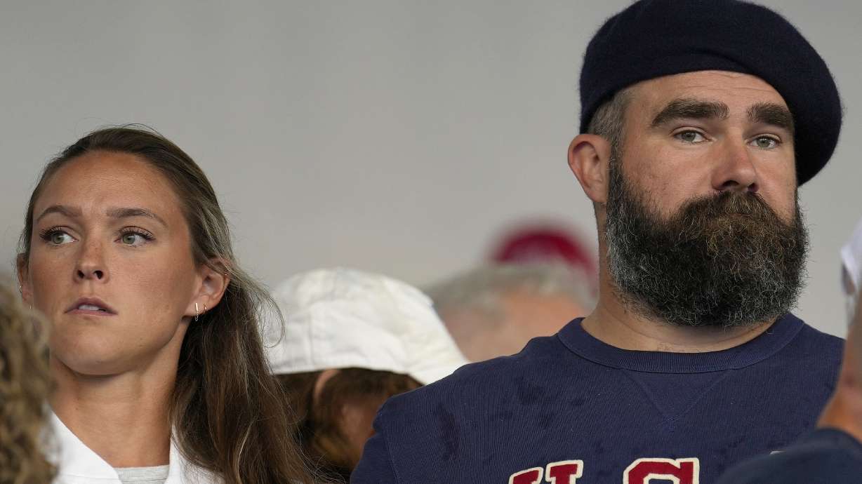 FILE- Jason Kelce and wife Kylie watch the women's field hockey match between the Argentina and United States, at the Yves-du-Manoir Stadium, at the 2024 Summer Olympics, Saturday, July 27, 2024, in Colombes, France.