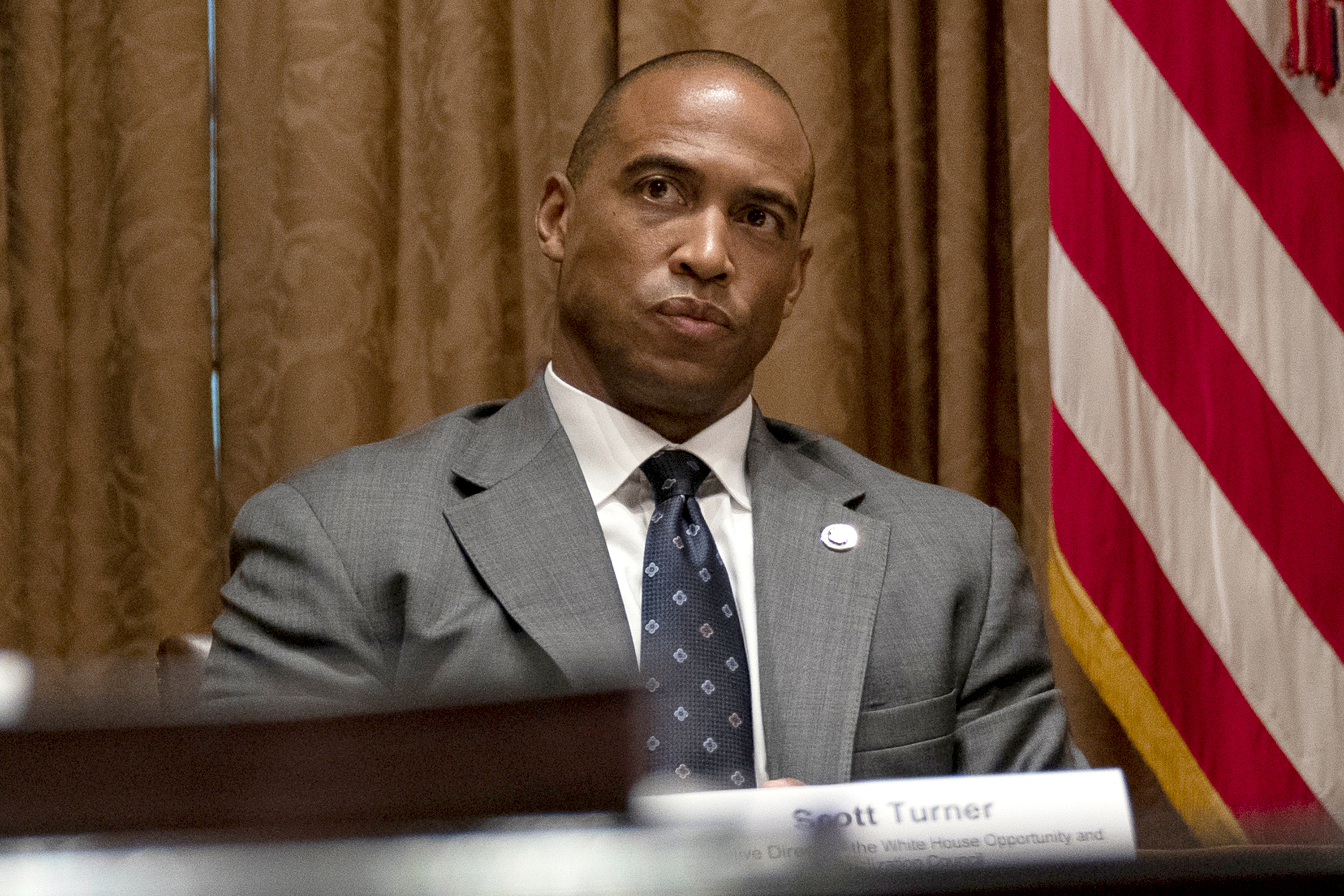 FILE - Scott Turner, the executive director of the White House Opportunity and Revitalization Council, attends a meeting in the Cabinet Room of the White House, May 18, 2020, in Washington. 