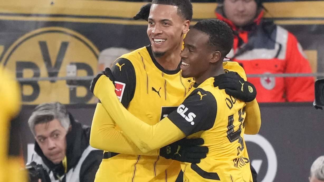 Dortmund's Jamie Bynoe-Gittens, right, celebrates after scoring with his teammate Felix Nmecha during the German Bundesliga soccer match between Borussia Dortmund and SC Freiburg at the Signal-Iduna Park in Dortmund, Germany, Saturday, Nov. 23, 2024.