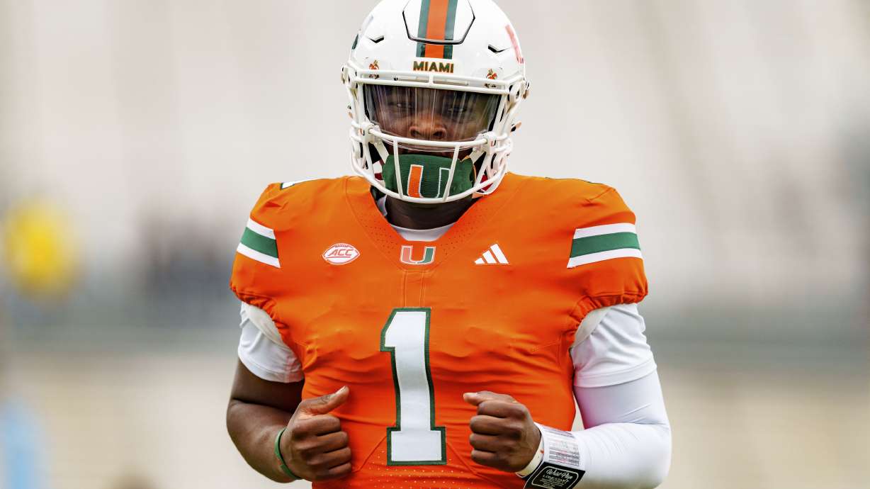 Miami quarterback Cam Ward (1) warms up before an NCAA college football game against Georgia Tech, Saturday, Nov. 9, 2024, in Atlanta.