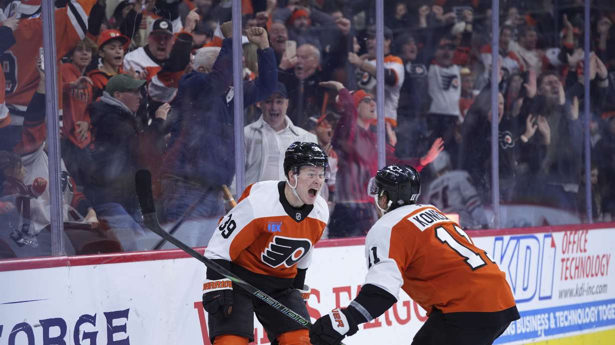 Philadelphia Flyers' Matvei Michkov, left, and Travis Konecny celebrate after Michkov scored the game-winning goal during overtime in an NHL hockey game against the Chicago Blackhawks, Saturday, Nov. 23, 2024, in Philadelphia.