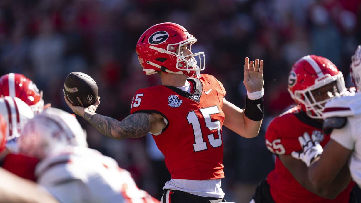 Georgia quarterback Carson Beck (15) throws from the pocket during the first half of an NCAA college football game against UMass, Saturday, Nov. 23, 2024, in Athens, Ga.