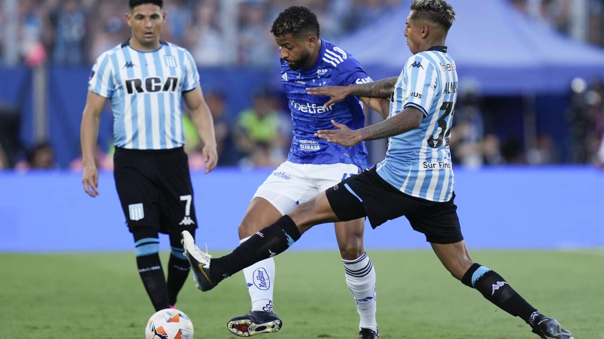 Agustin Almendra, right, of Argentina's Racing Club and Joao Marcelo of Brazil's Cruzeiro battle for the ball during the Copa Sudamericana final soccer match in Asuncion, Paraguay, Saturday, Nov. 23, 2024.