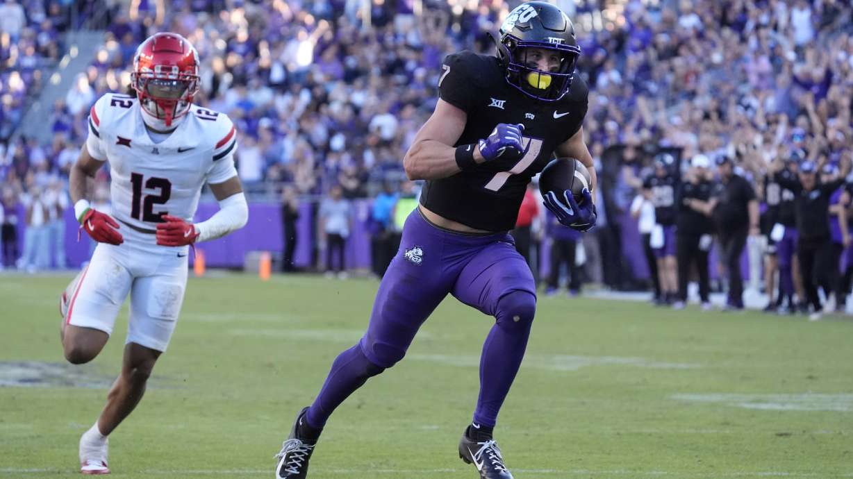 TCU wide receiver JP Richardson (7) scores a touchdown ahead of Arizona defensive back Genesis Smith (12) during the second half of an NCAA college football game Saturday, Nov. 23, 2024, in Fort Worth, Texas.