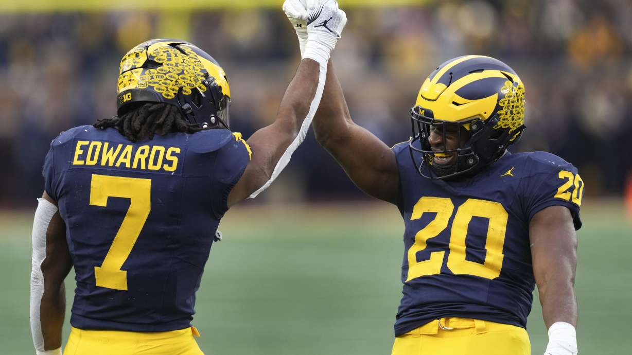 Michigan running back Kalel Mullings (20) celebrates his two-yard touchdown run with Donovan Edwards (7) in the first half of an NCAA college football game against Northwestern in Ann Arbor, Mich., Saturday, Nov. 23, 2024.