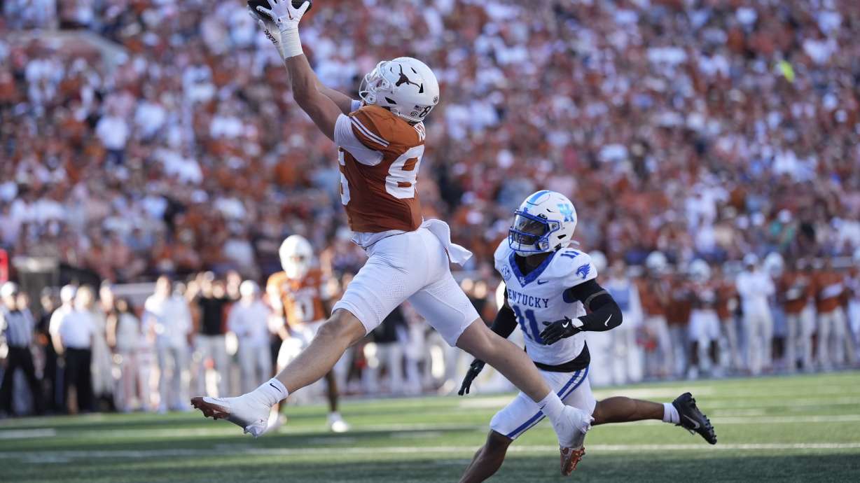 Texas tight end Gunnar Helm (85) makes a catch over Kentucky defensive back Zion Childress (11) for a touchdown during the first half of an NCAA college football game in Austin, Texas, Saturday, Nov. 23, 2024.