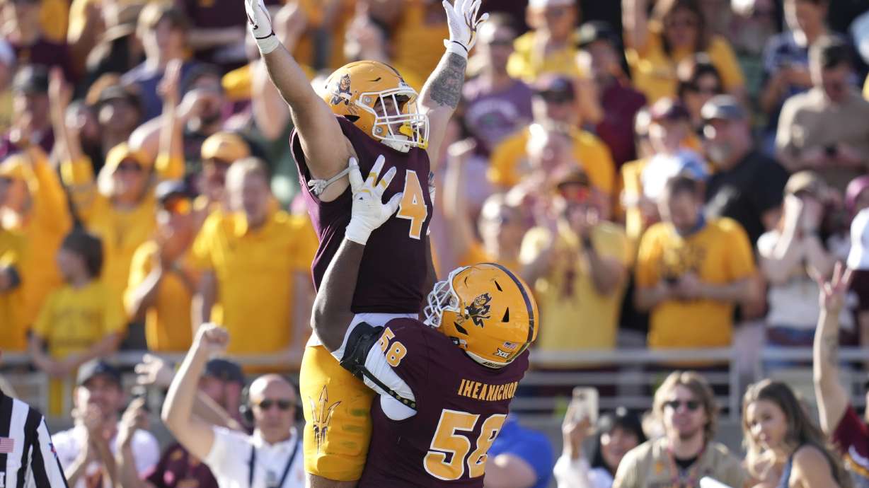 Arizona State running back Cam Skattebo (4) celebrates a touchdown run against BYU with offensive lineman Max Iheanachor (58) during the first half of an NCAA college football game Saturday, Nov. 23, 2024, in Tempe, Ariz.