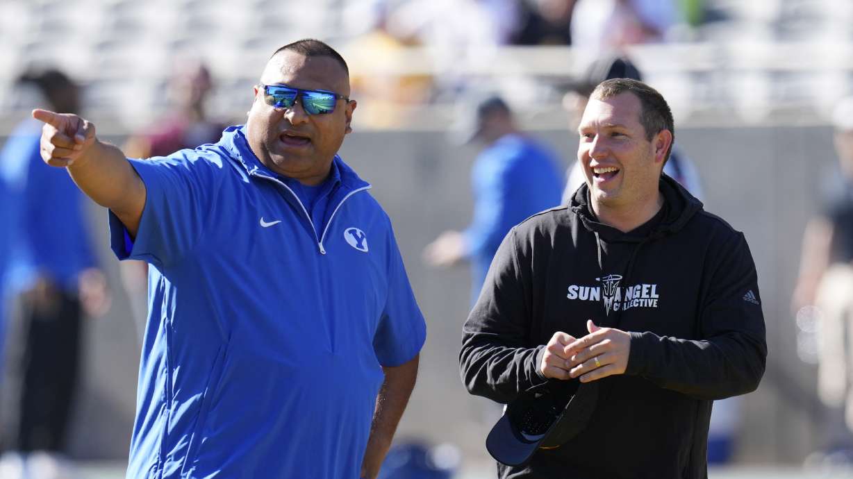 BYU head coach Kalani Sitake, left, talks with Arizona State head coach Kenny Dillingham before an NCAA college football game Saturday, Nov. 23, 2024, in Tempe, Ariz.