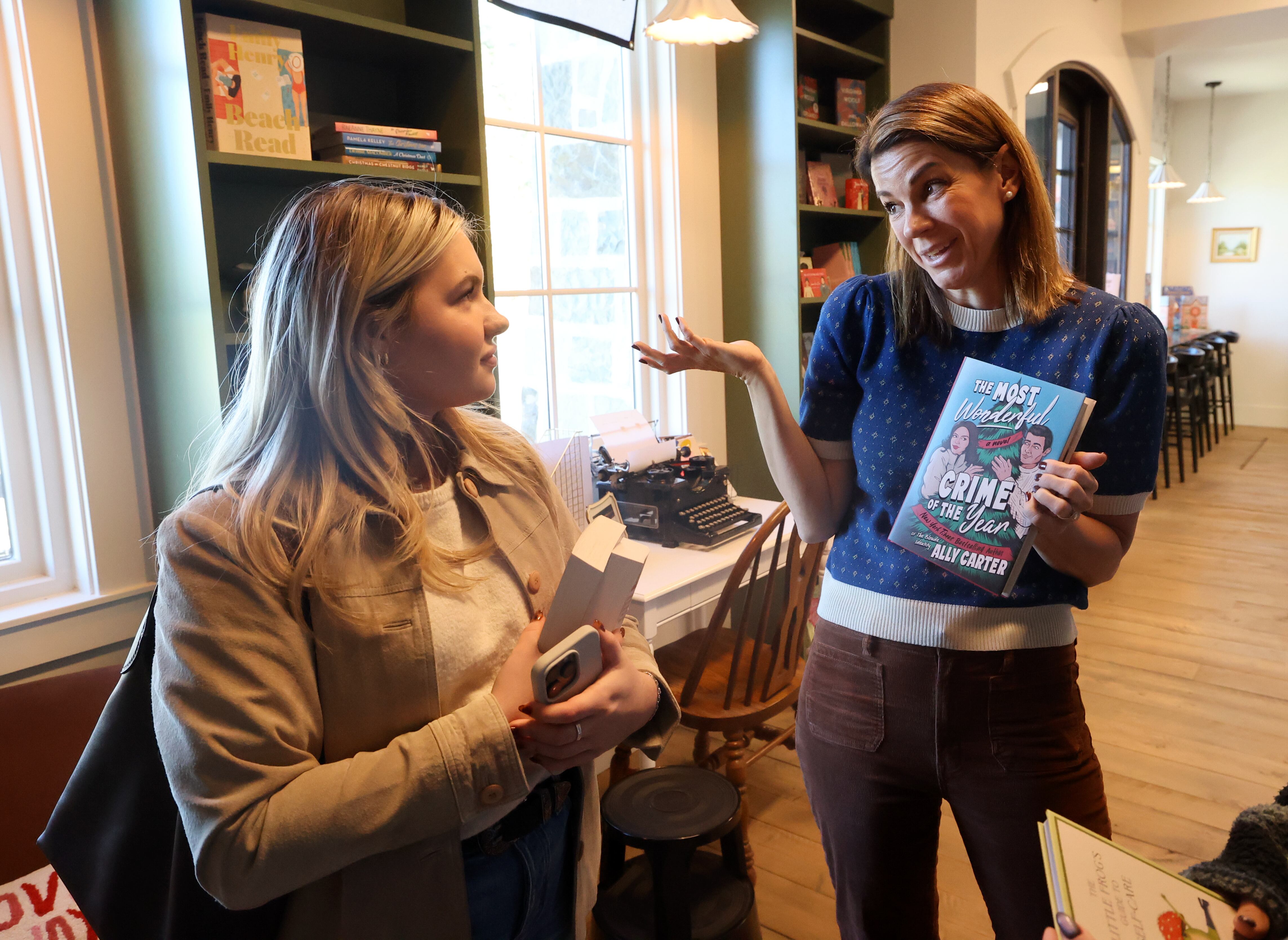 Folklore Bookshop co-owner Lindsey Leavitt Brown, right, tells Layla Basic about different books at Folklore Bookshop in Midway on Nov. 6.