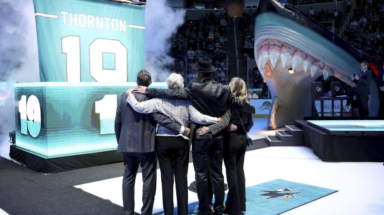 Joe Thornton, second from right, hugs members of his family during a ceremony to retire his jersey before an NHL Hockey game between the San Jose Sharks and the Buffalo Sabres, Saturday, Nov. 23, 2024 in San Jose, California.