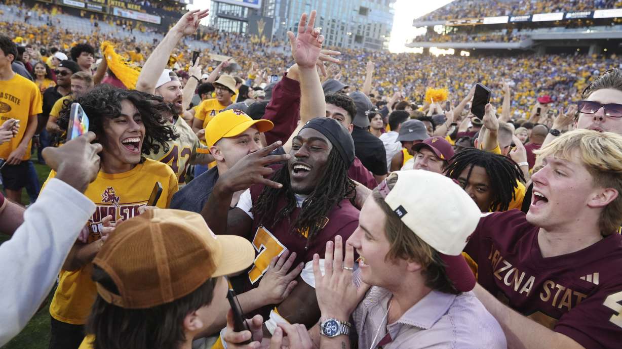 Arizona State defensive back Shamari Simmons, center, celebrates with fans following a 28-23 win over BYU in an NCAA college football game Saturday, Nov. 23, 2024, in Tempe, Ariz.