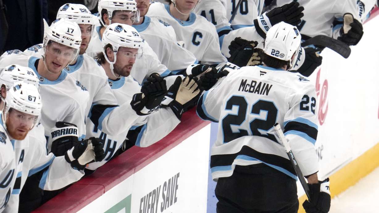 Utah Hockey Club's Jack McBain (22) returns to the bench after scoring during the first period of an NHL hockey game against the Pittsburgh Penguins, Saturday, Nov. 23, 2024, in Pittsburgh.
