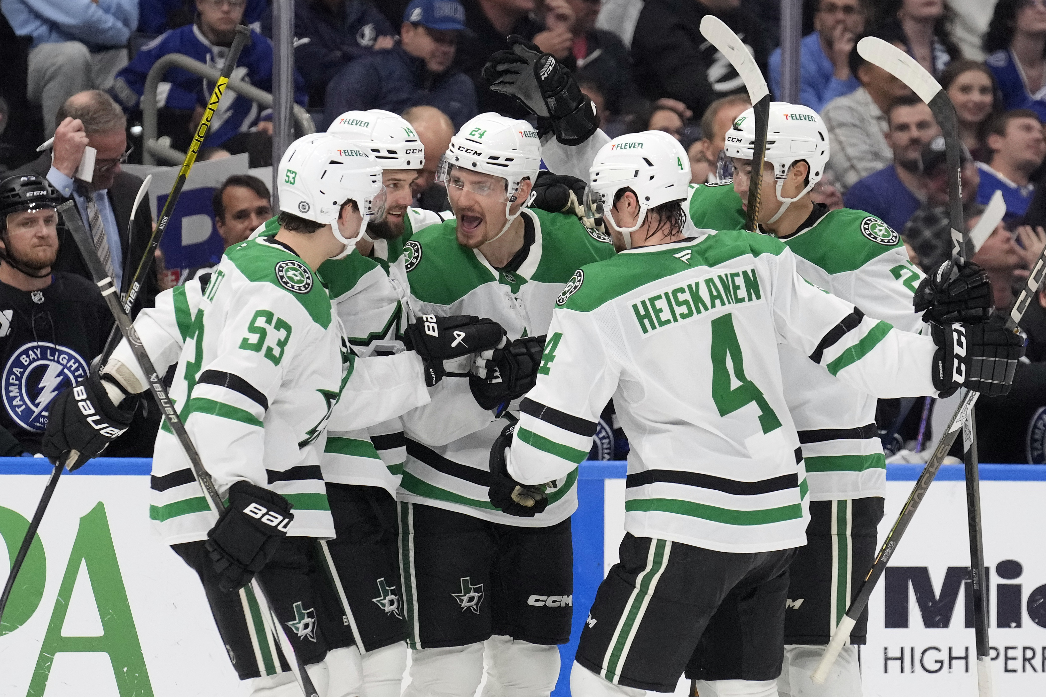 Dallas Stars center Roope Hintz (24) celebrates his goal against the Tampa Bay Lightning with center Wyatt Johnston (53) and defenseman Miro Heiskanen (4) during the third period of an NHL hockey game Saturday, Nov. 23, 2024, in Tampa, Fla. 