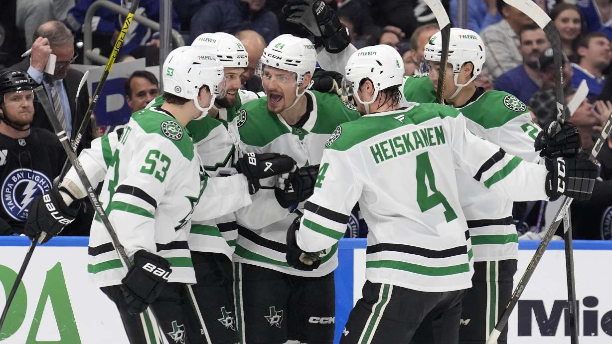 Dallas Stars center Roope Hintz (24) celebrates his goal against the Tampa Bay Lightning with center Wyatt Johnston (53) and defenseman Miro Heiskanen (4) during the third period of an NHL hockey game Saturday, Nov. 23, 2024, in Tampa, Fla.