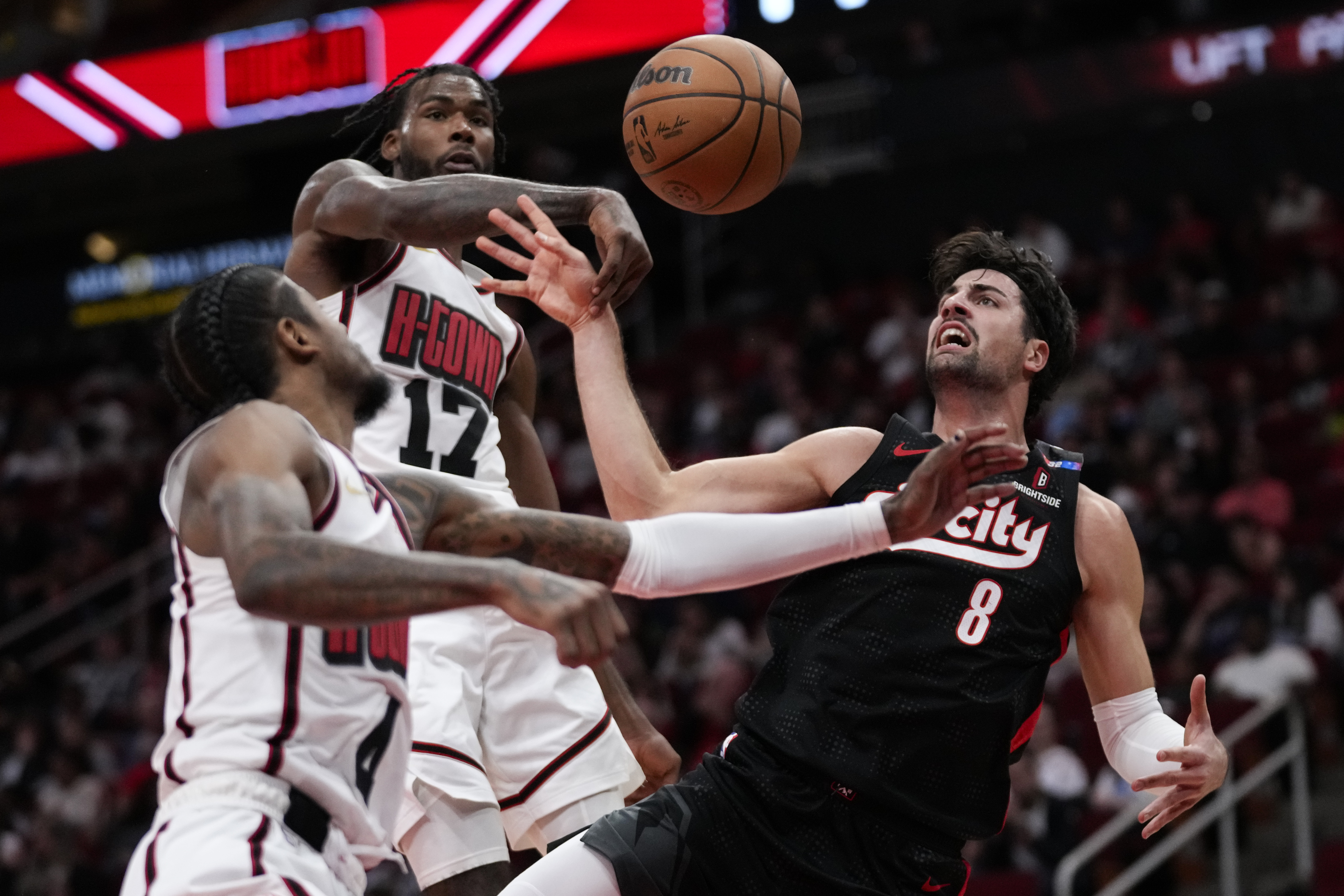 Houston Rockets forward Tari Eason (17) and guard Jalen Green (4) defend against Portland Trail Blazers forward Deni Avdija (8) during the first half of an NBA basketball game in Houston, Saturday, Nov. 23, 2024.