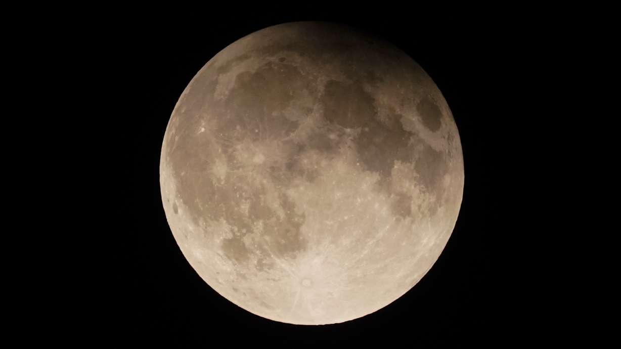 A supermoon with a partial lunar eclipse rises over Lake Michigan in Chicago, Sept. 17.