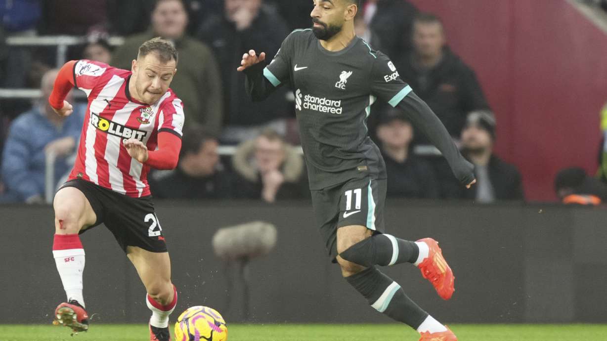Southampton's Ryan Fraser, left, and Liverpool's Mohamed Salah fight for the ball during the English Premier League soccer match between Southampton and Liverpool in Southampton, England, Sunday, Nov. 24, 2024.