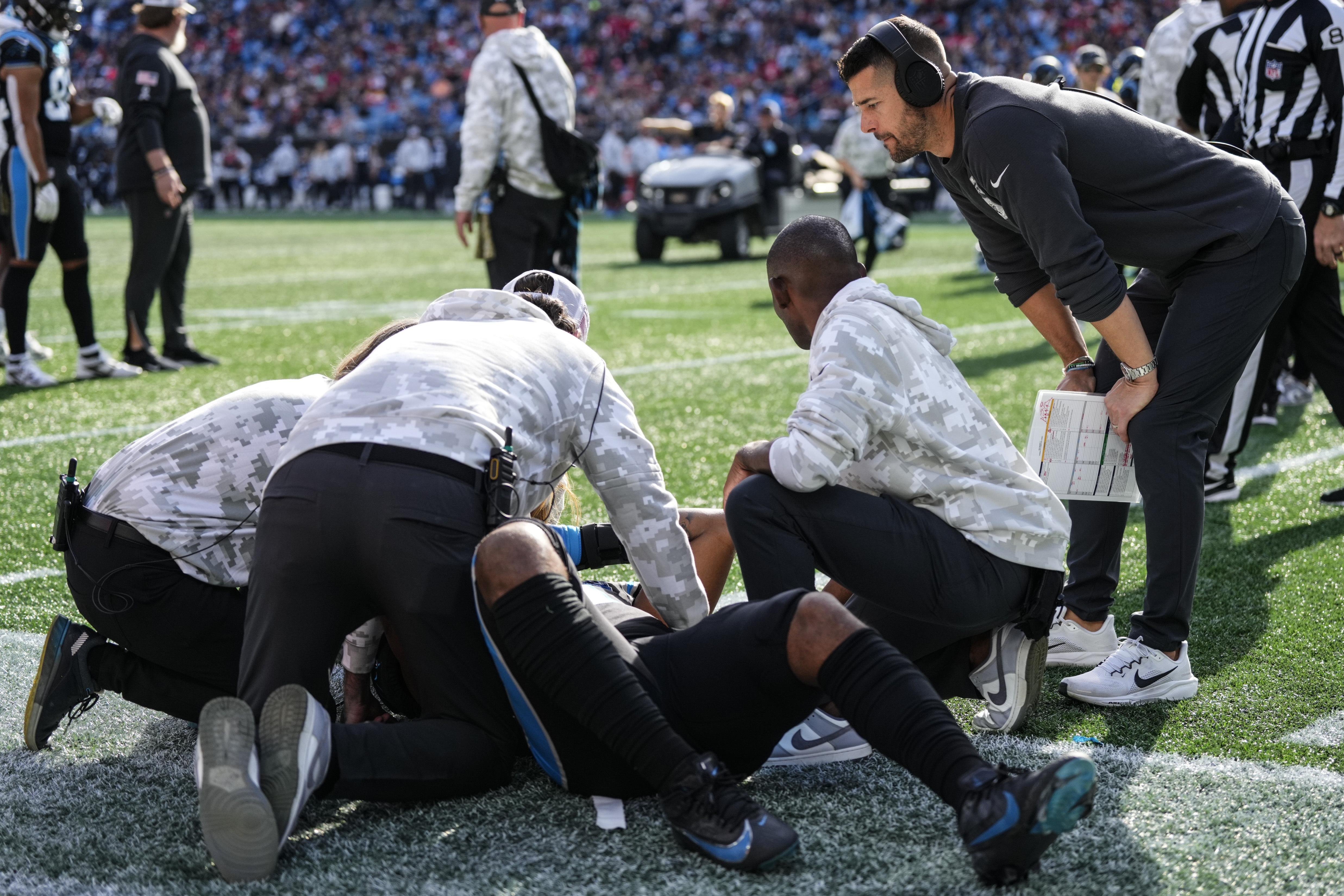 Carolina Panthers tight end Ja'Tavion Sanders (0) is helped by staff after injury against the Kansas City Chiefs during the first half of an NFL football game, Sunday, Nov. 24, 2024, in Charlotte, N.C.