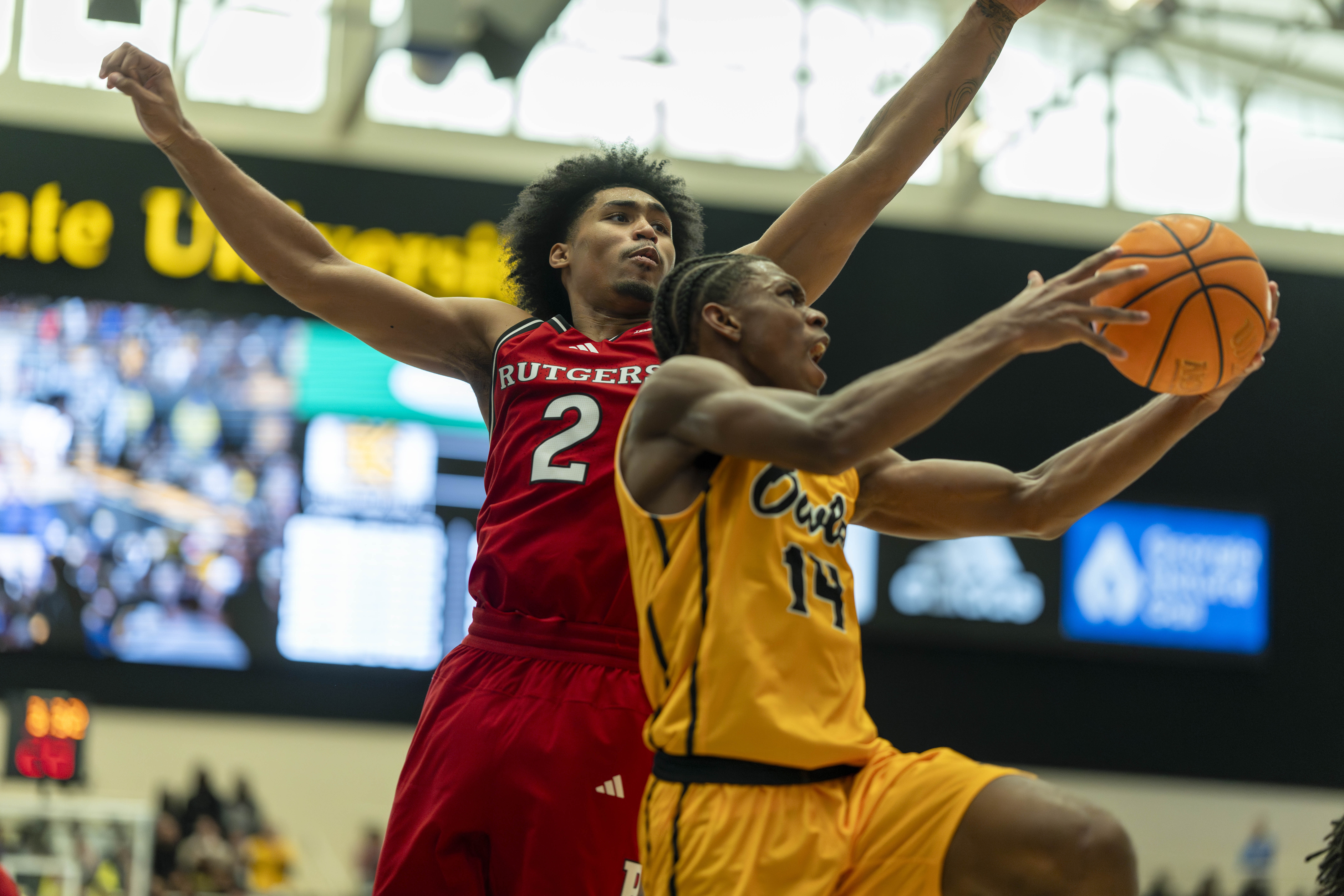 Rutgers guard Dylan Harper (2) defends against Kennesaw State guard Adrian Wooley (14) during the first half of an NCAA college basketball game, Sunday, Nov. 24, 2024, in Kennesaw, Ga.