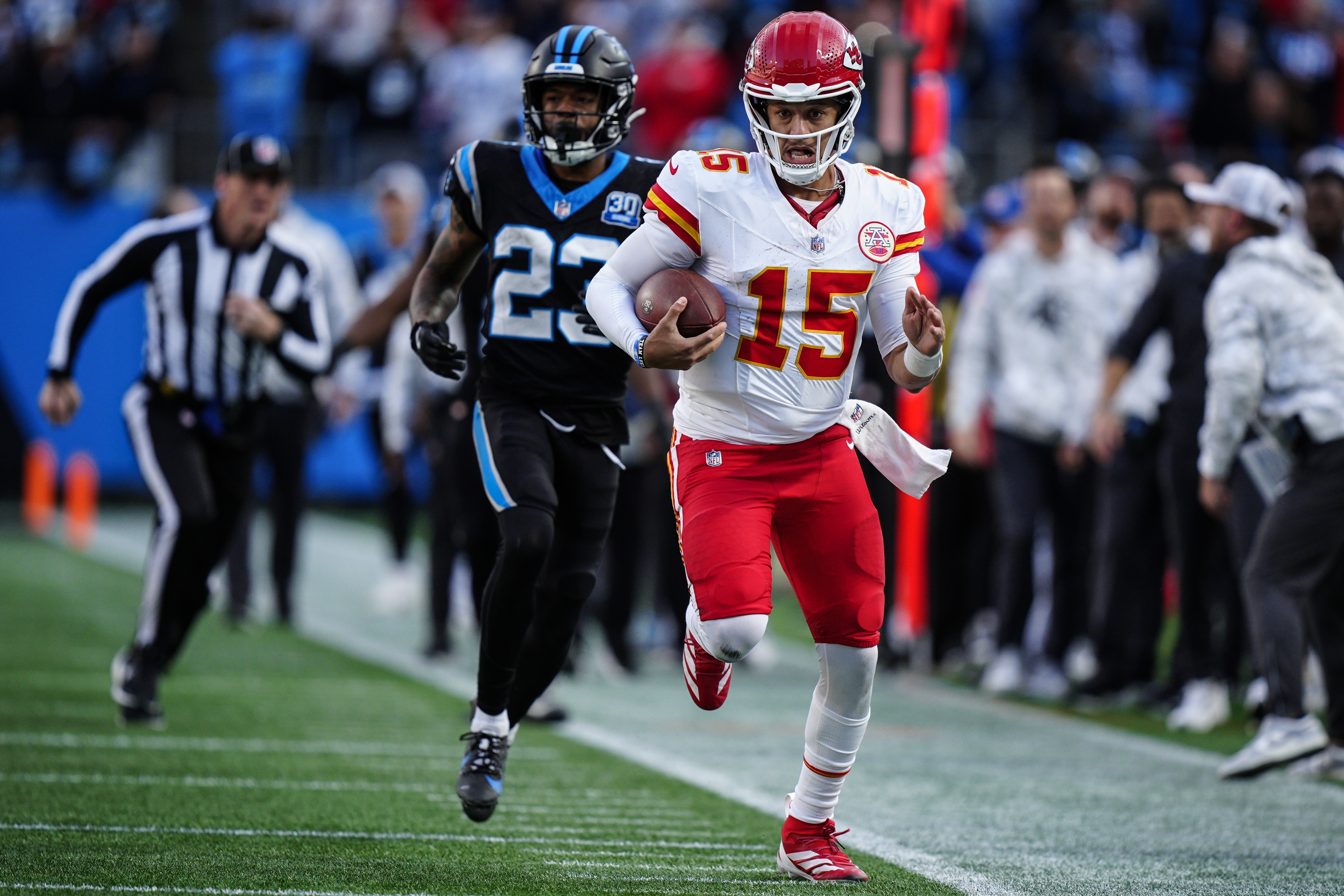 Kansas City Chiefs quarterback Patrick Mahomes (15) runs in overtime against the Carolina Panthers during an NFL football game, Sunday, Nov. 24, 2024, in Charlotte, N.C. 