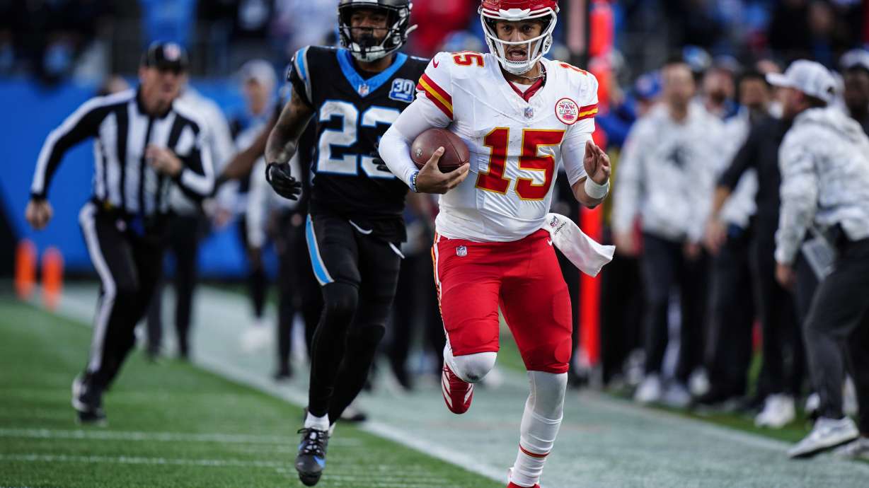 Kansas City Chiefs quarterback Patrick Mahomes (15) runs in overtime against the Carolina Panthers during an NFL football game, Sunday, Nov. 24, 2024, in Charlotte, N.C.