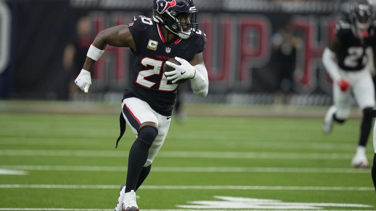 Houston Texans safety Jimmie Ward (20) returns an interception for a touchdown during the second half an NFL football game against the Tennessee Titans, Sunday, Nov. 24, 2024, in Houston.