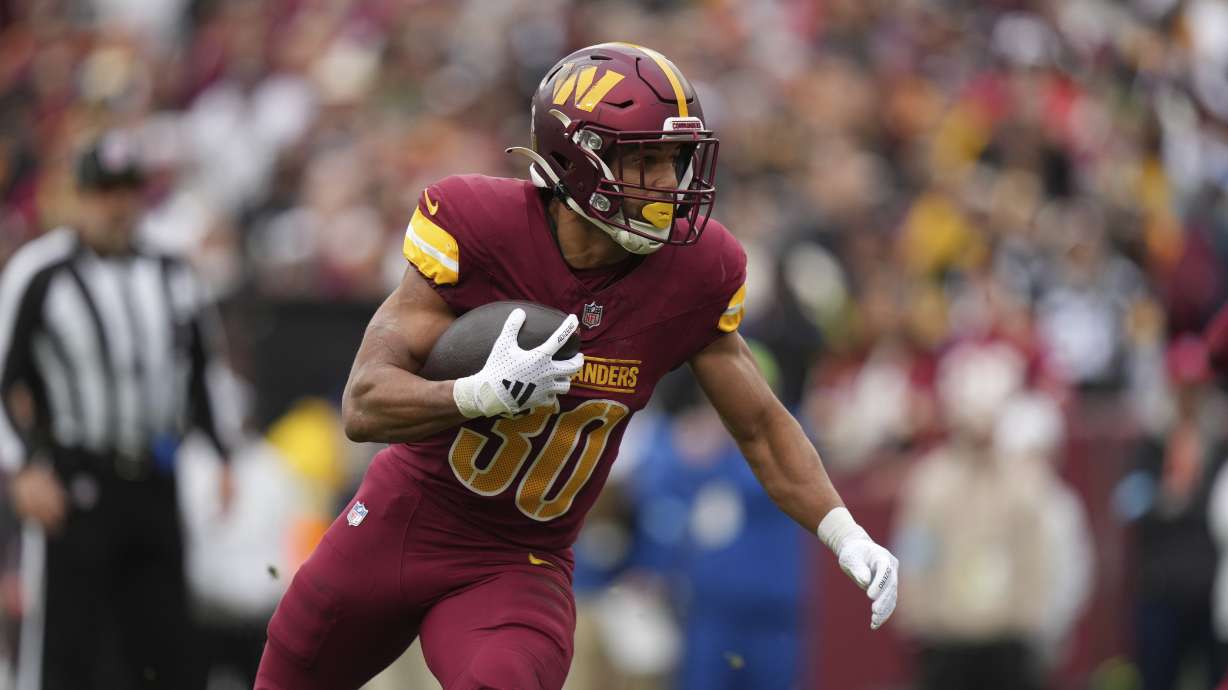 Washington Commanders running back Austin Ekeler rushes for a 1-yard rushing touchdown during the first half of an NFL football game against the Pittsburgh Steelers, Sunday, Nov. 10, 2024, in Landover, Md.