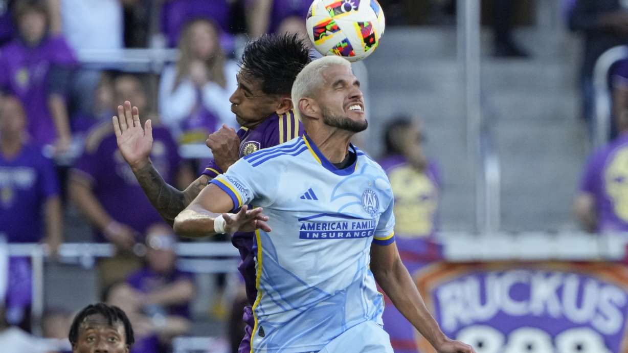 Atlanta United's Luis Abram, center right, and Orlando City's Facundo Torres, center left, go up for control of a head ball during the first half of an MLS Semifinal Conference playoff soccer match, Sunday, Nov. 24, 2024, in Orlando, Fla.