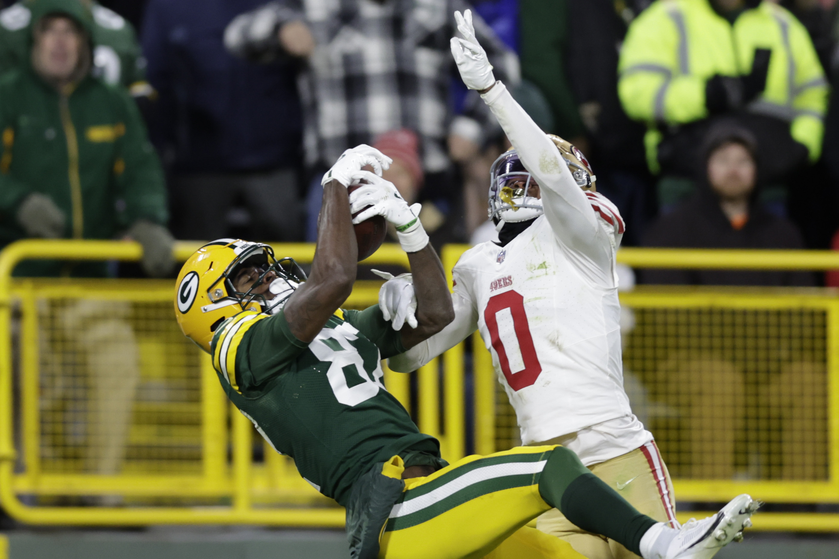 San Francisco 49ers cornerback Renardo Green (0) breaks up a pass and is called for pass interference against Green Bay Packers wide receiver Romeo Doubs (87) during the second half of an NFL football game on Sunday, Nov. 24, 2024 in Green Bay, Wis. 