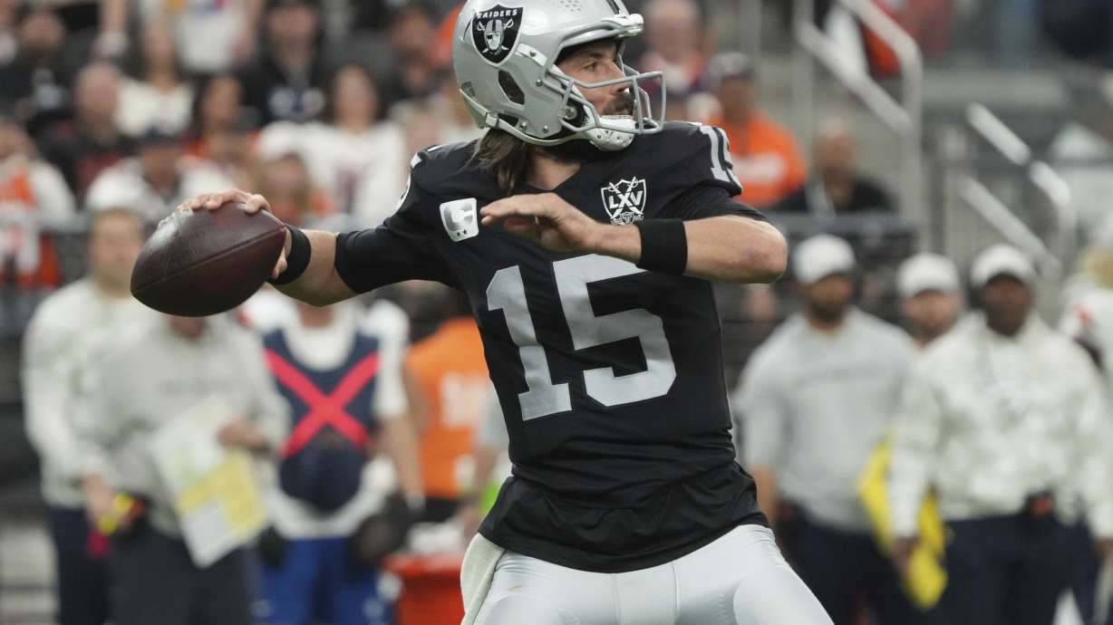 Las Vegas Raiders quarterback Gardner Minshew (15) throws against the Denver Broncos during the first half of an NFL football game, Sunday, Nov. 24, 2024, in Las Vegas.