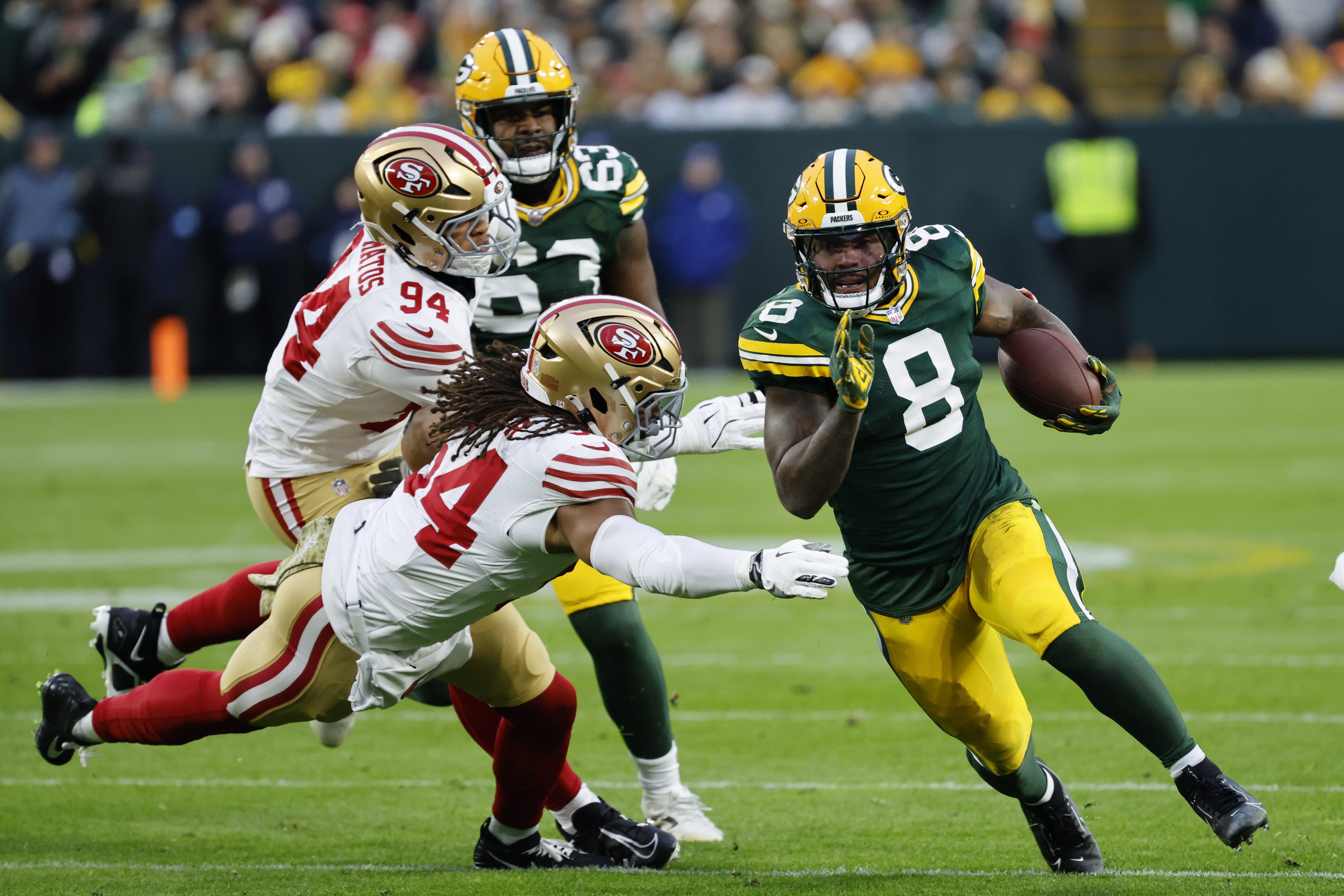 Green Bay Packers running back Josh Jacobs (8) runs the ball during the first half of an NFL football game against the San Francisco 49ers on Sunday, Nov. 24, 2024 in Green Bay, Wis.