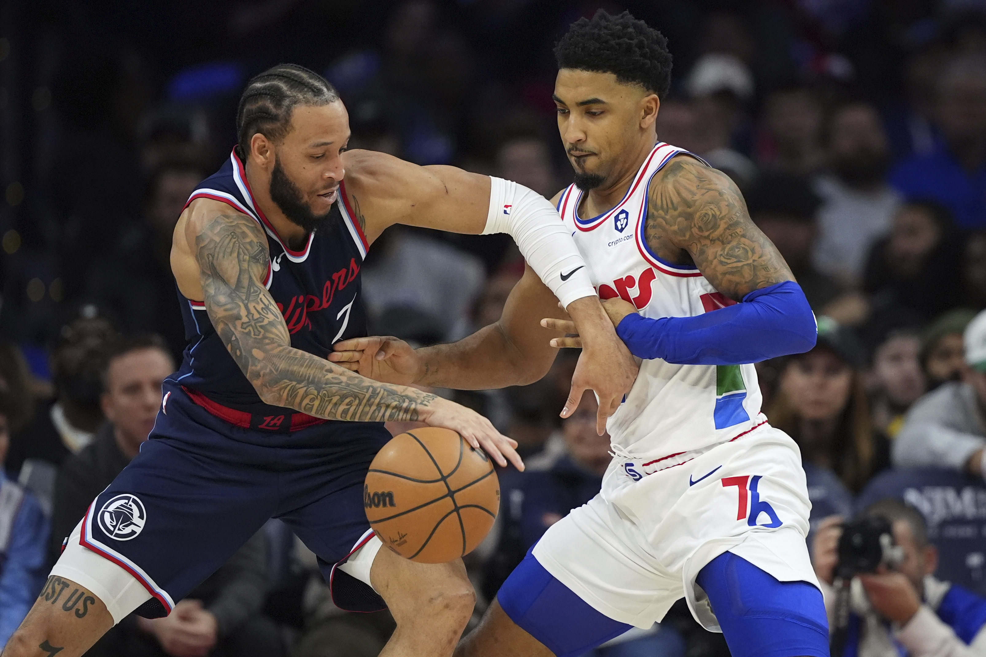 Los Angeles Clippers' Amir Coffey, left, tries to get past Philadelphia 76ers' KJ Martin during the first half of an NBA basketball game, Sunday, Nov. 24, 2024, in Philadelphia. 