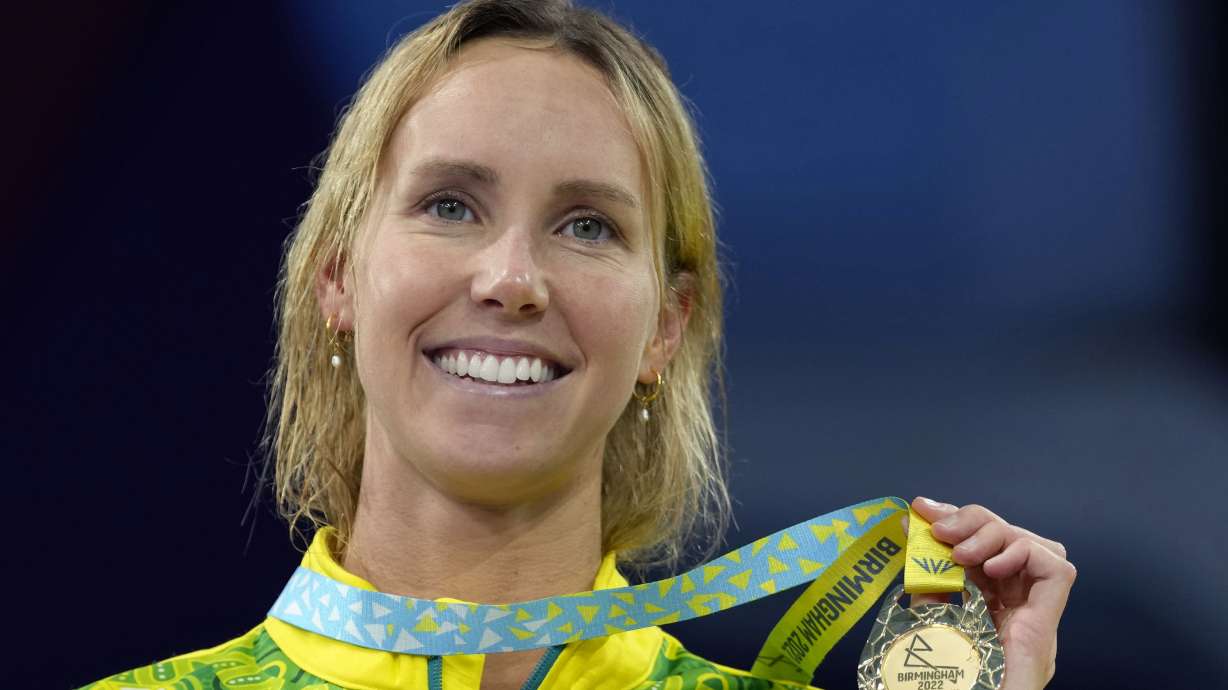 FILE - Emma McKeon of Australia poses after winning the gold medal in the Women's 50 meters butterfly final during the swimming competition of the Commonwealth Games, at the Sandwell Aquatics Centre in Birmingham, England, Monday, Aug. 1, 2022.