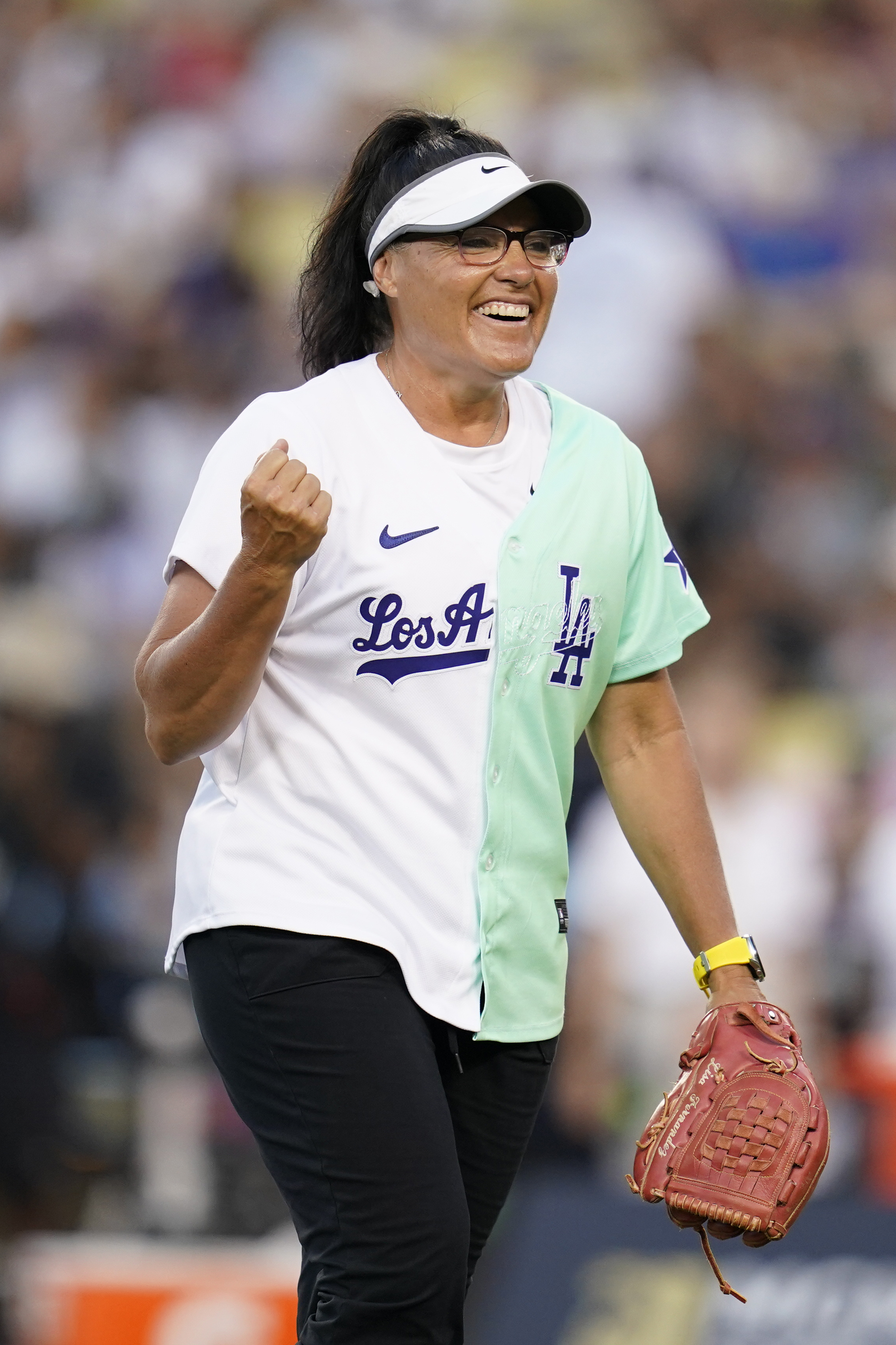 FILE - Former professional softball player Lisa Fernandez smiles on the field during the MLB All Star Celebrity Softball game, Saturday, July 16, 2022, in Los Angeles. 