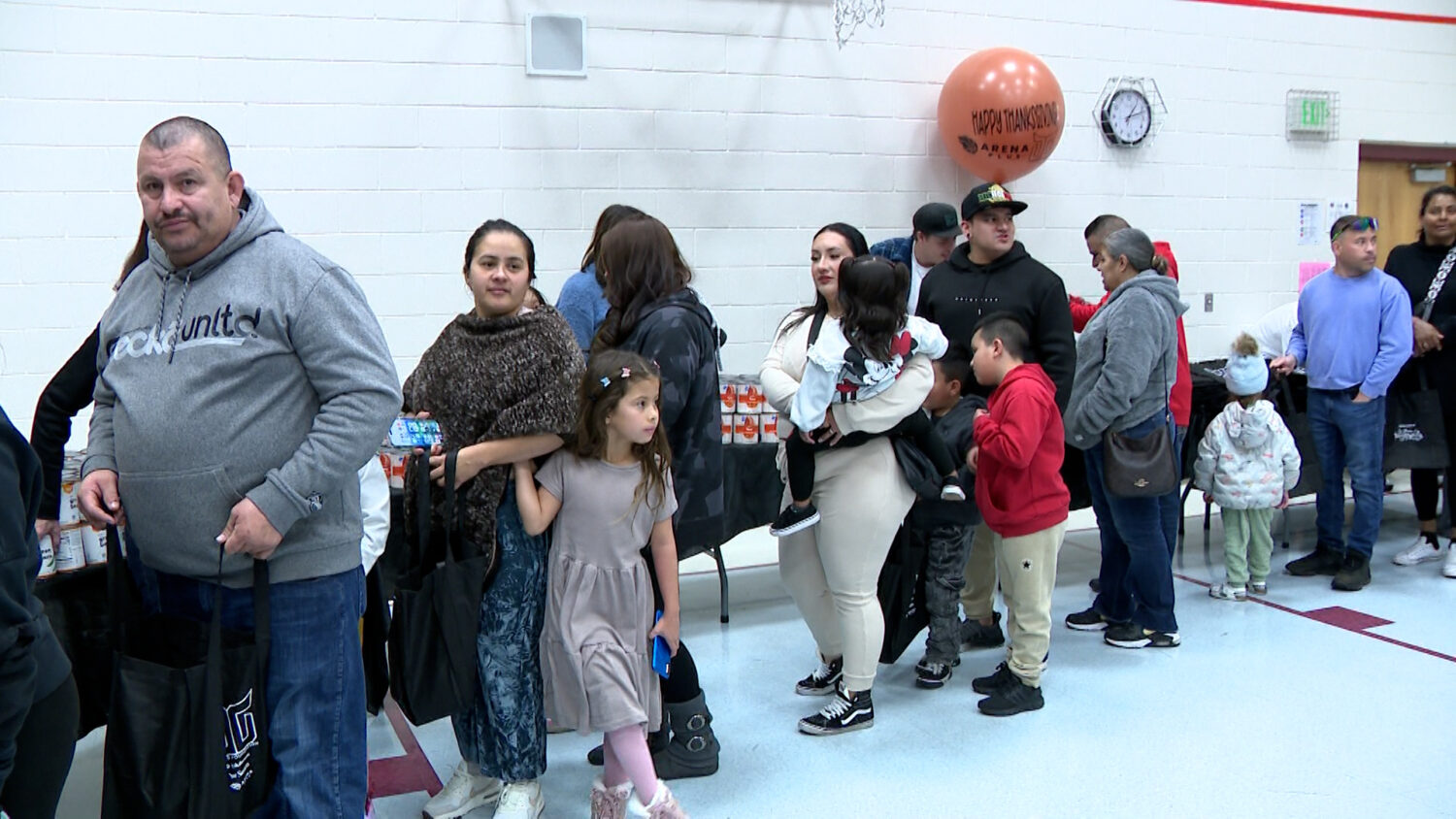 Several families stand in line to get food for Thanksgiving on Sunday, in West Jordan.