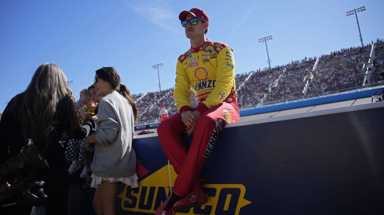 Joey Logano sits on the pit wall before a NASCAR Cup Series Championship auto race at Phoenix Raceway, Sunday, Nov. 10, 2024, in Avondale, Ariz.