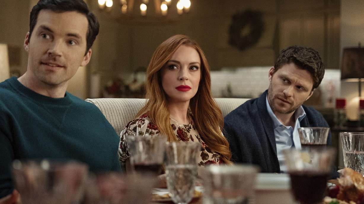 This image released by Netflix shows Ian Harding, from left, Lindsay Lohan and Jon Rudnitsky in a scene from "Our Little Secret."